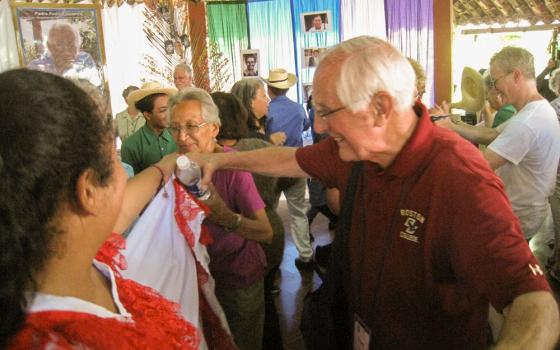 Detroit Auxiliary Bishop Tom Gumbleton is seen with St. Joseph Sr. Elena Jaramillo and folkloric dancers at La Pequeña Comunidad in Nueva Esperanza, El Salvador, in 2015. (Courtesy of SHARE El Salvador)