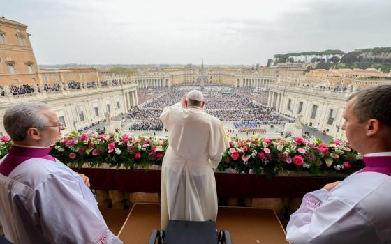 View from behind Pope Francis, as he waves over St. Peter's Square