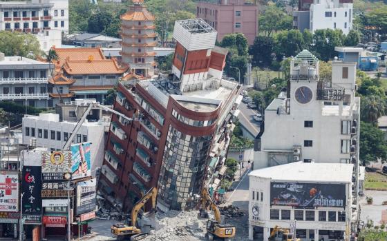 Collapsed buildings buckle towards street