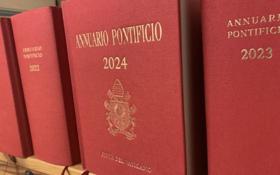 Red and gold front cover of Papal Yearbooks, arranged facing out on shelf