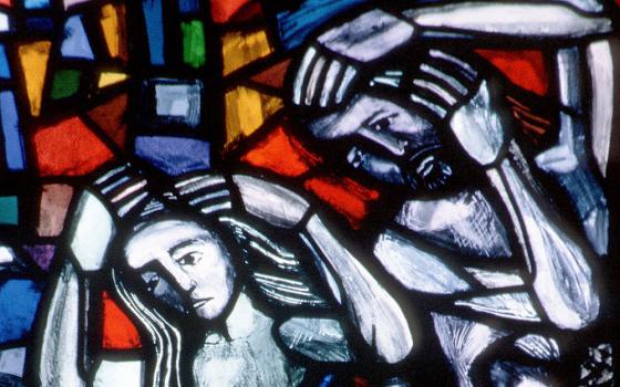 Adam and Eve are depicted in a stained-glass window at St. Nicolas Church in Feldkirch, Austria, in a 2004 file photo. (CNS photo from Crosiers)