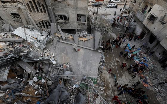 Palestinians inspect the site of Israeli airstrike on a house, amid the ongoing conflict between Israel and the Palestinian Islamist group Hamas, in Rafah, in the southern Gaza Strip, March 24, 2024. (OSV News/Reuters/Mohammed Salem)