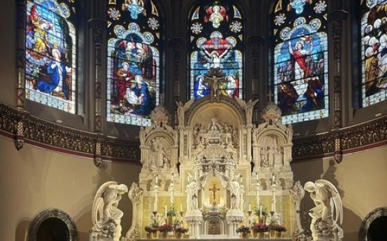 Ornate altar and stained glass windows.