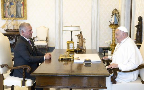 Pope and King sit across from each other at Pope's desk