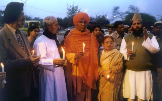 People stand at an interfaith peace gathering in New Delhi in this undated photo. 