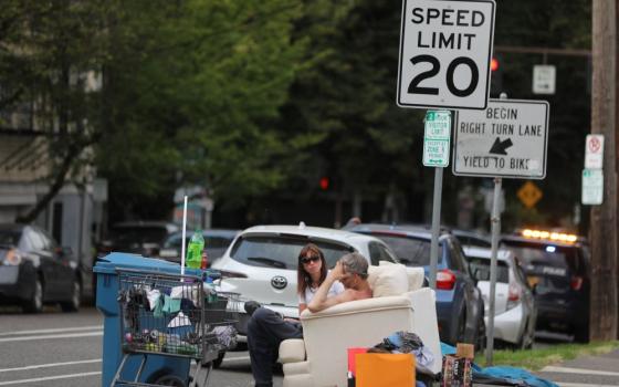 Homeless people chat on a couch outside St. Mary Cathedral of the Immaculate Conception in Portland, Ore., July 5, 2022. The U.S. Supreme Court ruled June 28 that a Grants Pass, Ore., law restricting homeless camps does not constitute cruel and unusual punishment. 