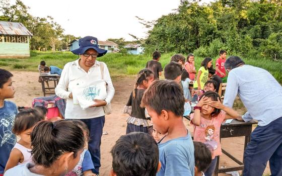 Dominican Sr. Zully Rojas Quispe takes part in an activity for children during one of her visits to the Indigenous communities of the Peruvian Amazon. (Courtesy of Zully Rojas Quispe)