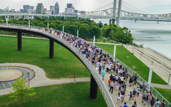 Hundreds of local Catholics processed with the Blessed Sacrament carried by Archbishop Shelton Fabre of Louisville, Kentucky, July 9 on the Louisville ramp to the Big Four Bridge. The bridge for pedestrians and cyclists connects Louisville to Jeffersonville, Indiana. The procession marked the end of the National Eucharistic Pilgrimage's July 4-9 route through the Louisville Archdiocese. (OSV News/The Record/Marnie McAllister)