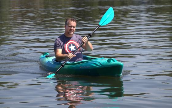 Man in kayak on water. 