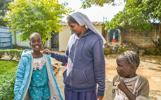 Immaculate Conception Sr. Theresa Kulandai engages the younger girls in conversation at Home of Joy, also known as Nyumba Yanga Orphanage, located on the grounds of the Marian Shrine in Lusaka, Zambia. (Derrick Silimina)