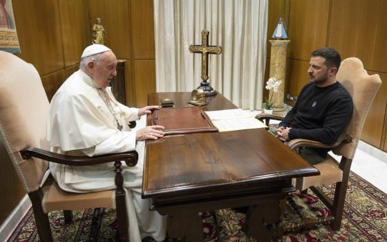 Pope Francis and President Zelenskyy sit across from each other at Pope's desk. 