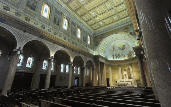 Vast, cavernous, and highly ornate sanctuary of empty church. 