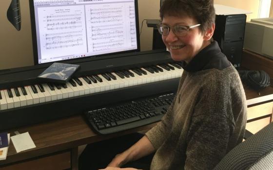 Sr. Claire Sokol, a member of the Order of Discalced Carmelites, sits with her composing equipment that she used to score the film "Thérèse: The Story of a Soul." (Claire Sokol)