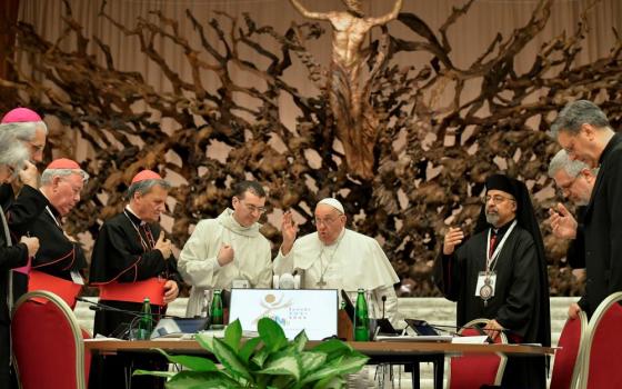 Pope Francis gives his blessing to members of the Synod of Bishops on synodality after the synod's final working session Oct. 26 in the Paul VI Audience Hall at the Vatican. The synod assembly released its final report after meeting in sessions since Oct. 2. (CNS/Vatican Media)