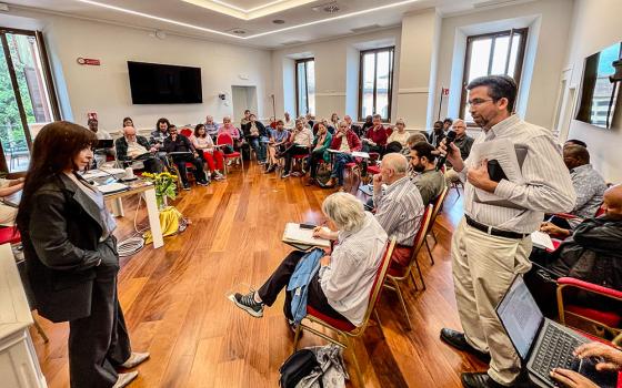 Emilce Cuda, secretary at the Pontifical Commission for Latin America, and Kevin Ahern, Manhattan University theology professor, speak at a session of the Lay Mission and Vocation Conference in Rome on Oct. 11. (NCR photo/Camillo Barone)