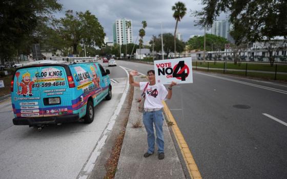 Sonja Kahkonen, an anti-abortion Catholic, holds a sign urging voters to reject Amendment 4, which would have enshrined abortion rights in Florida, on Nov. 5 outside a polling place at the Coliseum in St. Petersburg. The amendment won support from 57% of voters, but required 60% voter approval to amend the state constitution. (AP/Rebecca Blackwell)
