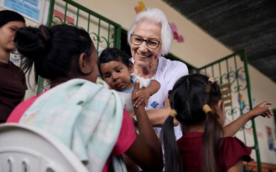 Scalabrinian Sr. Rosita Milesi, recipient of the 2024 Nansen Refugee Award from the Office of the United Nations High Commissioner for Refugees, holds baby Daniel Jose Milaro, who has just arrived from Venezuela with his mother Jenifer Milaro and siblings, at the Casa de Acolhida Sao Jose, a temporary shelter for refugees and migrants in Pacaraima, Brazil, Aug. 24, 2024. (UNHCR/Marina Calderon/Handout via Reuters)