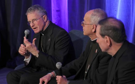 Archbishop Timothy Broglio of the U.S. Archdiocese for the Military Services, president of the U.S. Conference of Catholic Bishops, speaks during a news conference at a Nov. 12 session of the conference's fall general assembly in Baltimore. Also pictured are Bishops Mark Seitz of El Paso, Texas, and Michael Burbidge of Arlington, Virginia. (OSV News/Bob Roller)