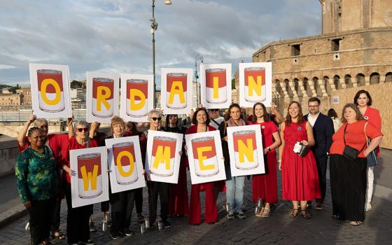 Activists from the Women's Ordination Conference hold a witness on the opening day of the synod on synodality Oct. 2 in sight of the Vatican, with the message "Don't kick the can down the road." The final document did not call for movement on the issue of women deacons but it kept the issue open. (Courtesy of Women's Ordination Conference)