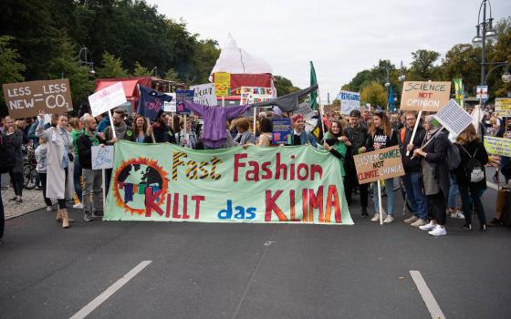 People carry signs against fast fashion during a Fridays For Future climate protest in Berlin in September 2019. (Wikimedia Commons/Stefan Müller)