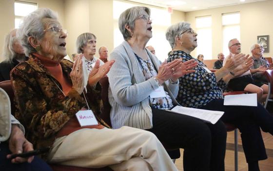 Spiritus community members Marilyn Nagle, Darlene Stout and Grace D'Amato clap during a Nov. 3 prayer service in Beavercreek, Ohio. (NCR photo/Dennis Sadowski)