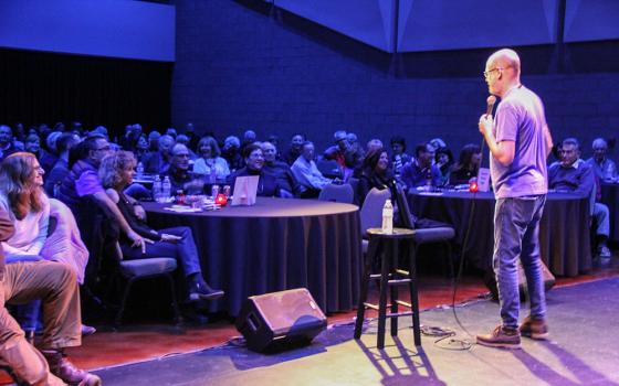 Erik Angel on stage during one of his recent standup comedy shows (Courtesy of Comedy for Peace)