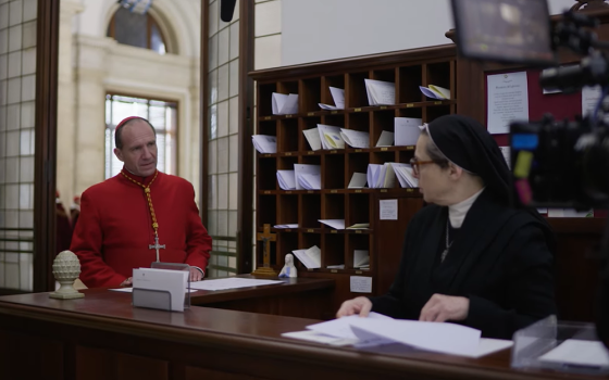 Ralph Fiennes is pictured playing Cardinal Lawrence with Isabella Rossellini as Sister Agnes in a screengrab of behind the scenes footage for director Edward Berger's "Conclave." (NCR/YouTube/Focus Features)