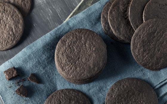 Chocolate wafer cookies on a blue cloth and a wooden table (Dreamstime/Bhofack2)