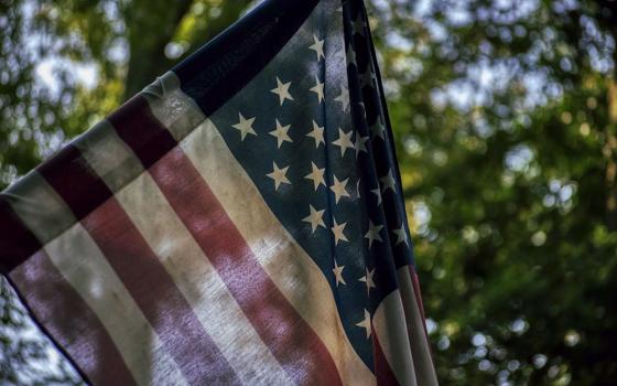 An American flag is pictured in this photo illustration. (Unsplash/Robin Jonathan Deutsch)