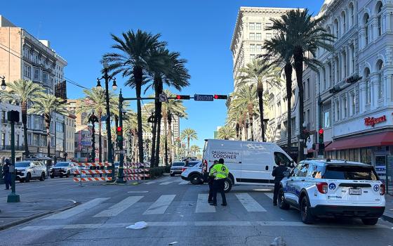 An Orleans Parish coroner's van is parked at the corner of Bourbon and Canal streets after a pickup truck drove into a large crowd in the French Quarter of New Orleans Jan. 1, 2025. (OSV News/Reuters/Brian Thevenot)