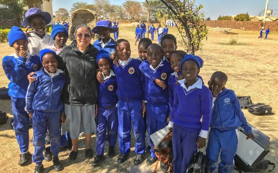 Our Lady of Sorrows Sr. Delnise Silva shares a light moment with children from Our Lady of Sorrows Primary School in rural Zimbabwe. (Marko Phiri)