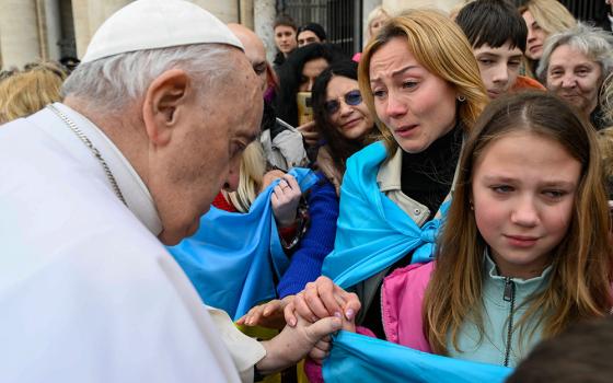 Pope Francis greets Ukrainian refugees after his weekly general audience in St. Peter's Square at the Vatican March 8, 2023. (CNS/Vatican Media)
