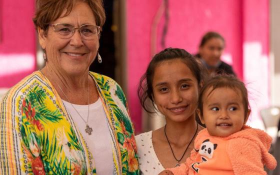 Sr. Suzanne Jabro, a member of the Sisters of Saint Joseph of Carondelet, stands with a woman and child living at the Cobina Posada del Migrante Shelter in Mexicali, Mexico, which Jabro supplies with essentials through her nonprofit Border Compassion. (Courtesy of Border Compassion)