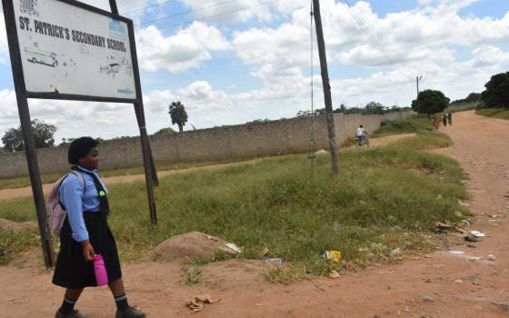 A girl walks to St. Patrick's Secondary School to attend classes. More than 100 vulnerable girls at St. Patrick's Secondary School have participated in the Bakhita Partnership for Education, overcoming financial hardships and societal challenges to stay in school. (Derrick Silimina)