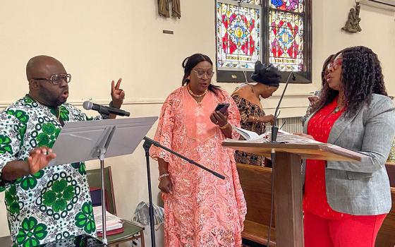 Paul Ezegamba, left, leads the choir at St. Clement Pope Church in Queens in New York City on Sunday, May 25, 2025. (Michael Aromolaran)