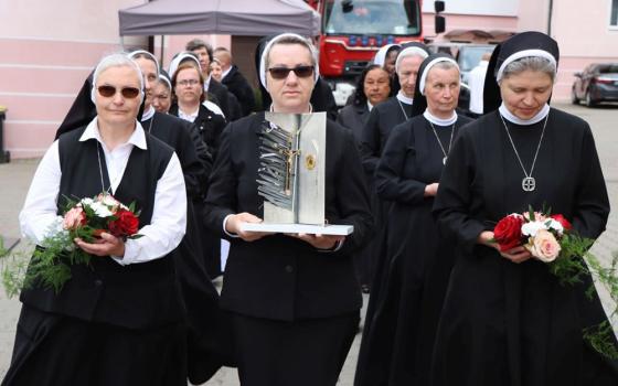A nun carries the reliquary during a ceremony on May 31, 2025, in Braniewo, Poland, as the church beatifies 15 nuns from the Congregation of St. Catherine Virgin and Martyr, martyred in 1945. (OSV News/Courtesy of Polish bishops' conference)