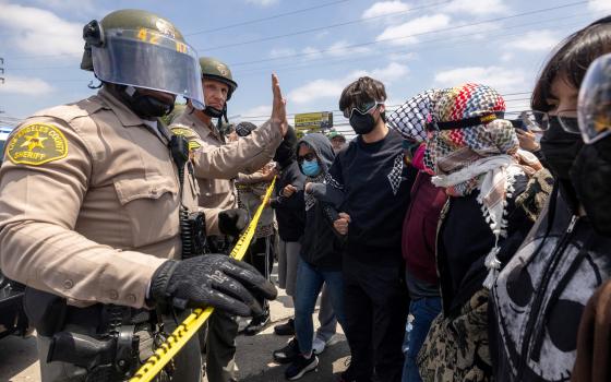 Los Angeles County Sheriff's deputies maintain a cordon following multiple detentions by Immigration and Customs Enforcement in Compton, Calif., June 7, 2025. (OSV News/Reuters/Barbara Davidson)