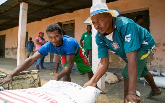 Workers unload food supplies from Catholic Relief Services and USAID in the village of Behera, near Tulear, Madagascar, Oct. 22, 2016. The Trump administration this year has cut about $60 billion in aid to humanitarian projects around the world. (OSV News/Catholic Relief Services/Nancy McNally)
