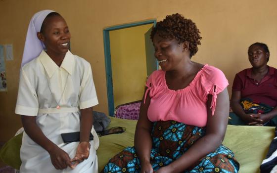 Holy Spirit Sr. Joyce Miyanda interacts with an expectant mother.