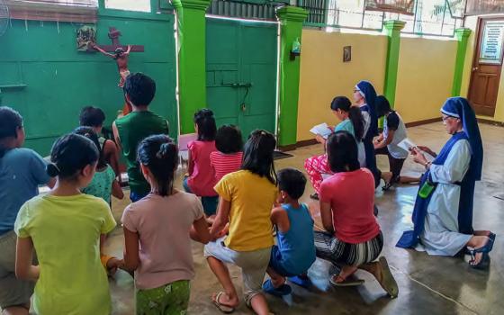A group of children pray together with the sisters in the Holy Trinity Home for Children, an orphanage dedicated to caring for sexually abused and impoverished children. (Courtesy of Trinitarian Handmaids of the Divine Word)