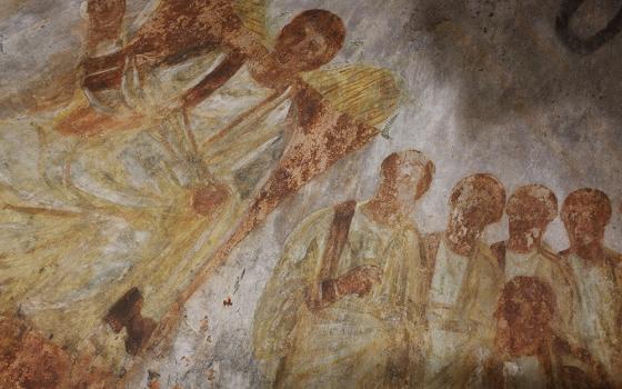 Jesus is seated on a throne with his disciples at his side in this fresco seen during the unveiling of two newly restored burial chambers in the Christian catacombs of St. Domitilla in Rome on May 30, 2017. (CNS/Carol Glatz)
