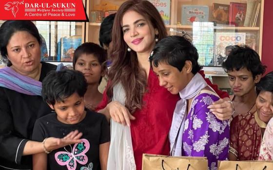 Humaira Asghar poses with children at Dar-ul-Sukun, Karachi, Pakistan, on April 16, 2024. Asghar, whose decomposed body was found July 8, visited the center six times between 2017 and 2024. (Courtesy of Dar-ul-Sukun)