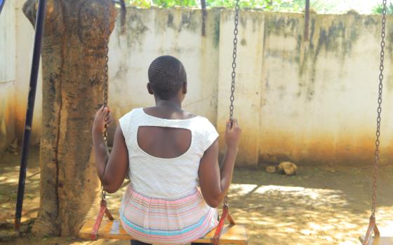 A girl sits alone on a swing at Mahali Pa Usalama, a safe haven run by Catholic sisters for survivors of sexual exploitation. (GSR photo/Doreen Ajiambo)