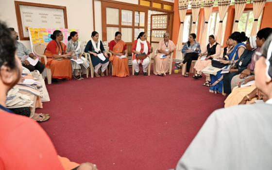 Women religious and transgender individuals engage in a group discussion. 
