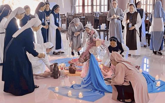 Sisters with lit candles in hands attend the opening ceremony of the first ever sabbatical course on March 18 at the Rosary Retreat House in Lam Dong province of Vietnam. (Courtesy photo)