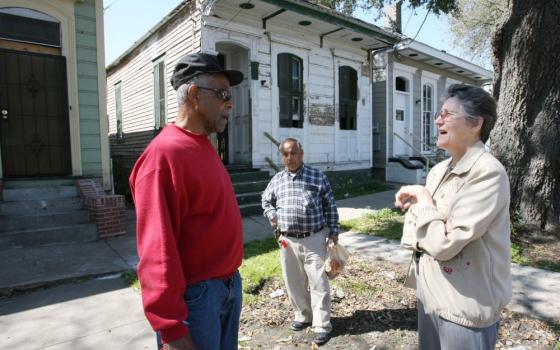 Sr. Vera Butler, a Sister of the Presentation of the Blessed Virgin Mary, talks with a resident just returning to his New Orleans neighborhood six months after Hurricane Katrina. The Aug. 29, 2005, storm caused more than 1,392 deaths and caused untold damage in the Gulf Coast, particularly in New Orleans. (CNS/Nancy Wiechec) 