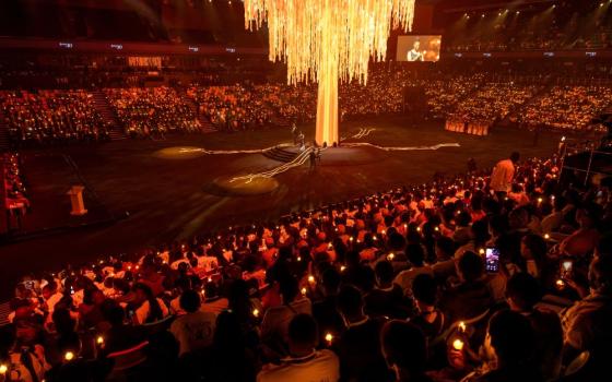 Participants hold a candlelit night vigil at the BK arena in Kigali, Rwanda, April 7, 2024, during a commemoration event, known as "Kwibuka" (Remembering) as the country marks the 30th anniversary of the 1994 genocide. OSV News/Reuters/Jean Bizimana)