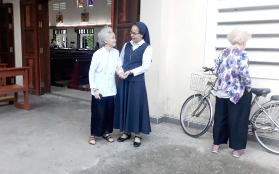 Sr. Anna Huynh Thi Dien talks with Nguyen Thi Nhai, an elderly woman without relatives, at Dong Hoa Church in Binh Duong province in Vietnam May 25. (Joachim Pham)