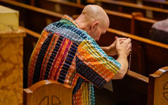 A worshipper prays prior to the annual "Pre-Pride Festive Mass" at St. Francis of Assisi Church in New York City June 29, 2024. The liturgy, hosted by the parish's LGBT+ ministry, is traditionally celebrated on the eve of the city's Pride parade. (OSV News/Gregory A. Shemitz)