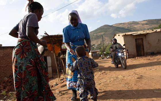 Elias Tembo and his mother, Catherine Mwale are pictured with Sr. Christabel Kazembe. Tembo and Mwale are beneficiaries of the Strengthening the Capacity of Religious Women in Early Childhood Development. The project trains mothers on early childhood nutrition, including the importance of locally sourced foods and complementary feeding practices. (Derrick Silimina)